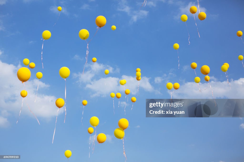 Balloon Ride Yellow Yellow Balloons Floating In Blue Sky High-Res Stock Photo - Getty Images