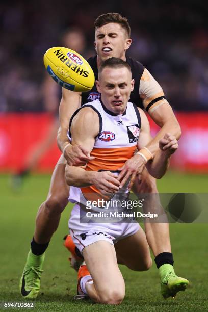Marc Murphy of the Blues tackles Tom Scully of the Giants during the round 12 AFL match between the Carlton Blues and the Greater Western Sydney...