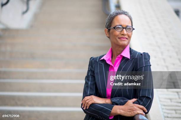 distinguished senior african american businesswoman - pink suit stock pictures, royalty-free photos & images