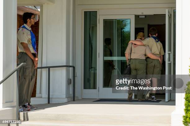 Melissa, left in the doorway and and Branimir, Udbinac walk into the services for Artem Ziberov at Neelsville Presbyterian Church on June 9, 2017 in...