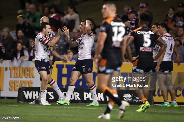 Luke Keary and Mitchell Pearce of the Roosters celebrate Pearce scoring a try during the round 14 NRL match between between the Wests Tigers and the...