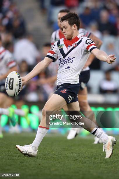 Luke Keary of the Roosters kicks during the round 14 NRL match between between the Wests Tigers and the Sydney Roosters at Campbelltown Sports...