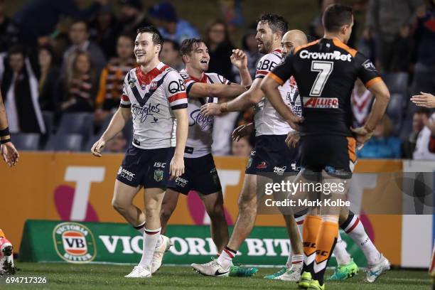Connor Watson of the Roosters celebrates with his team mates after scoring a try during the round 14 NRL match between between the Wests Tigers and...