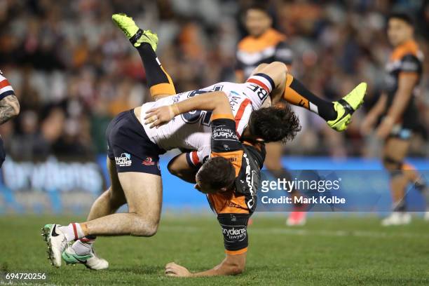 Aidan Guerra of the Roosters picks up and tackles Jack Littlejohn of the Tigers during the round 14 NRL match between between the Wests Tigers and...