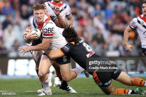 Dylan Napa of the Roosters is tackled by Aaron Woods of the Tigers during the round 14 NRL match between between the Wests Tigers and the Sydney...