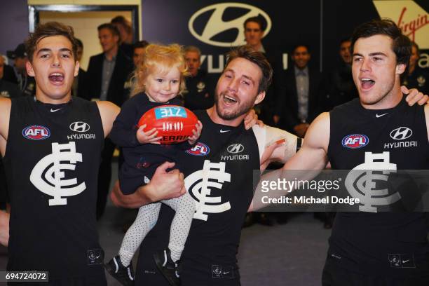 Dale Thomas of the Blues sing the club song after winning with daughter Matilda during the round 12 AFL match between the Carlton Blues and the...