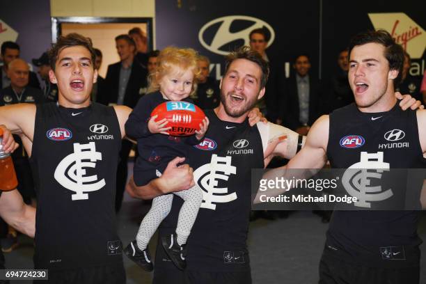 Dale Thomas of the Blues sing the club song after winning with daughter Matilda during the round 12 AFL match between the Carlton Blues and the...