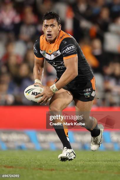 Elijah Taylor of the Tigers runs the ball during the round 14 NRL match between between the Wests Tigers and the Sydney Roosters at Campbelltown...