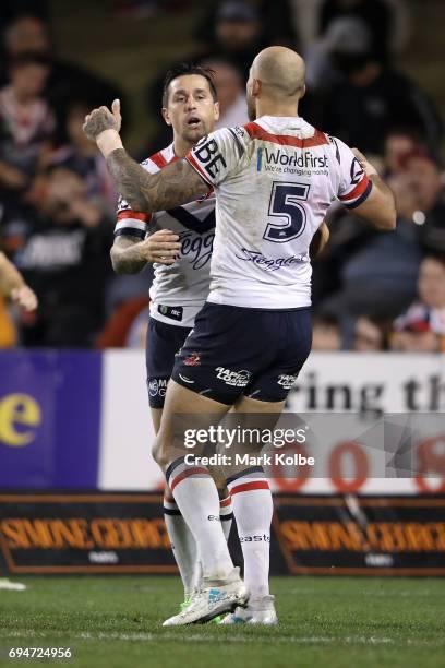 Mitchell Pearce of the Roosters celebrates with his team mate Blake Ferguson of the Roosters after scoring a try during the round 14 NRL match...