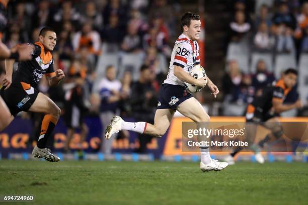 Luke Keary of the Roosters makes a break during the round 14 NRL match between between the Wests Tigers and the Sydney Roosters at Campbelltown...