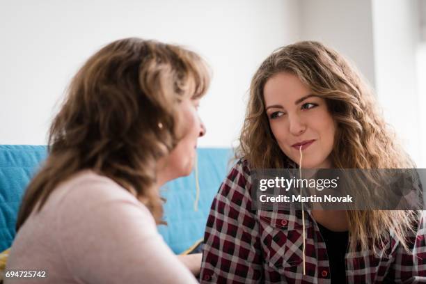 having fun together - mother and daughter and spaghetti - slurp stock pictures, royalty-free photos & images