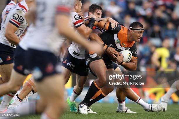 Ava Seumanufagai of the Tigers is tackled during the round 14 NRL match between between the Wests Tigers and the Sydney Roosters at Campbelltown...