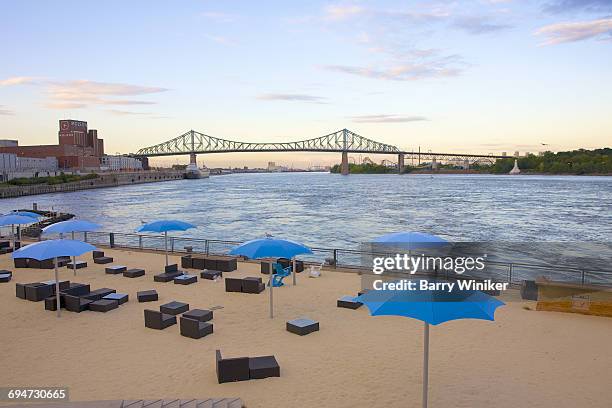 landmark bridge and beach at dusk, montreal - clock tower beach canada stock pictures, royalty-free photos & images