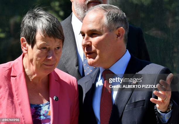 Germany's Environment Minister Barbara Hendricks and head of the Environmental Protection Agency Scott Pruitt talk prior to posing for a group photo...