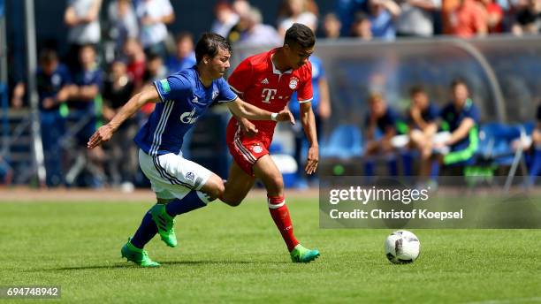 Andriko Smolinski of Schalke challenges Oliver Batista Meier of Bayern during the B Juniors German Championship Semi Final match between FC Schalke...