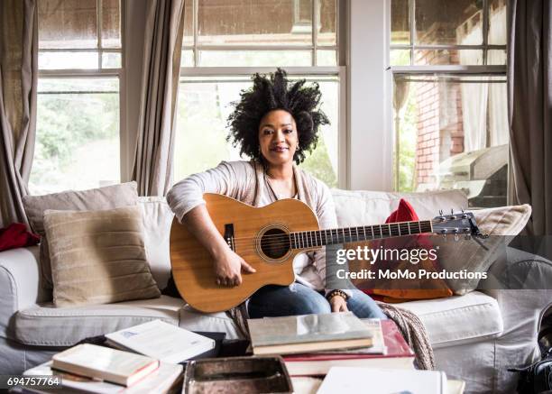 woman playing guitar at home - musician portrait stock pictures, royalty-free photos & images