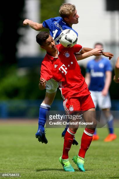 Tobias Wieschuss of Schalke and Oliver Batista Meier of Bayern go up for a header during the B Juniors German Championship Semi Final match between...