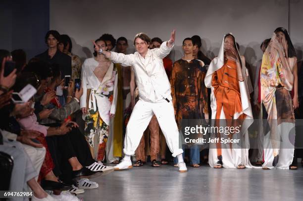 Fashion designer Alex Mullins and models on the runway after his show during the London Fashion Week Men's June 2017 collections on June 11, 2017 in...