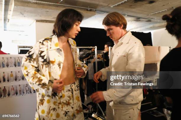 Designer Alex Mullins and a model are seen backstage ahead of the Alex Mullins show during the London Fashion Week Men's June 2017 collections on...
