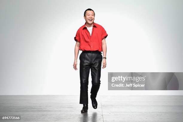 Designer Arashi Yanagawa appears on the runway following the runway at the John Lawrence Sullivan show during the London Fashion Week Men's June 2017...