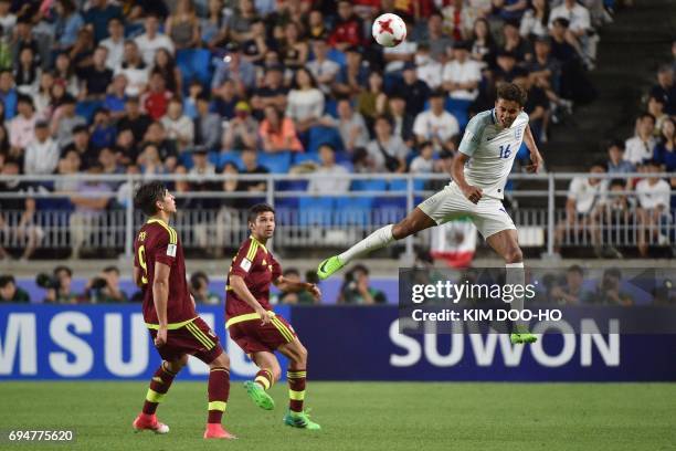 England's forward Dominic Calvert-Lewin heads the ball during the U-20 World Cup final football match between England and Venezuela in Suwon on June...