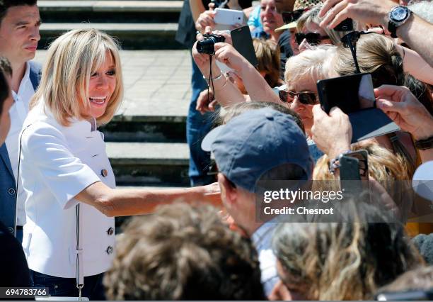 Wife of French President Emmanuel Macron, Brigitte Trogneux shakes hands with the public as she leaves the polling station of the town hall after...
