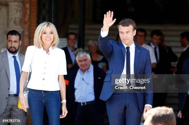 French President Emmanuel Macron and his wife Brigitte Trogneux leave the polling station of the town hall after casting their vote in the first...