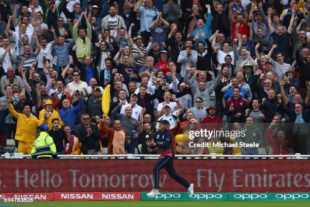 Jason Roy of England scoops the ball in play to take a spectacular catch to dismiss Glenn Maxwell off the bowling of Mark Wood during the ICC...