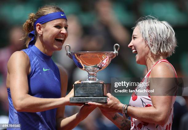 Bethany Mattek-Sands of United States and Lucie Safarova of Czech Republic pose with the trophy after their victory over Ashleigh Barty and Casey...