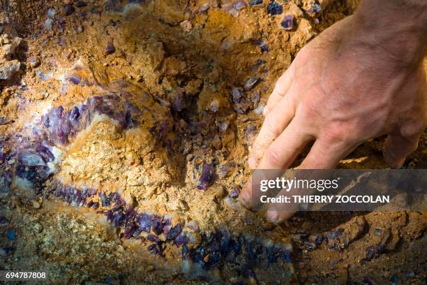 Nicolas Leger, an amateur gemologist, looks for amethysts on May 27, 2017 in Vernet-la-Varenne . / AFP PHOTO / Thierry Zoccolan