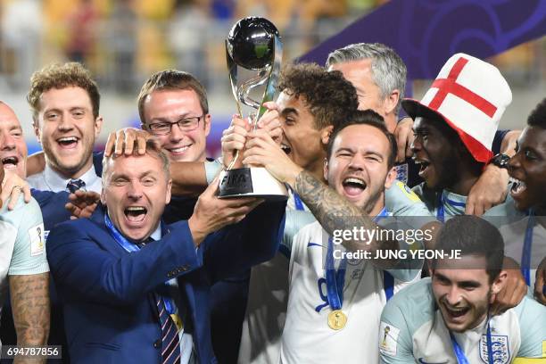 England's coach Paul Simpson celebrates with his players after winning the U-20 World Cup final football match between England and Venezuela in Suwon...