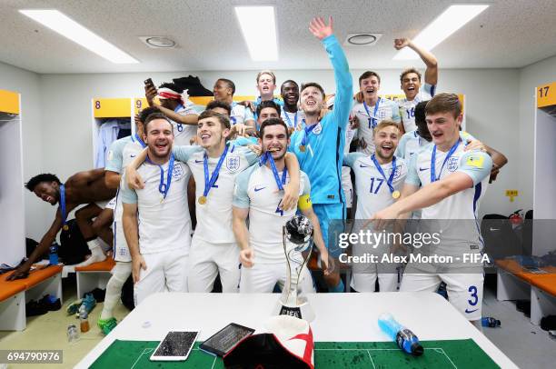 England players celebrate victory with the trophy in the dressing room after the FIFA U-20 World Cup Korea Republic 2017 Final between Venezuela and...