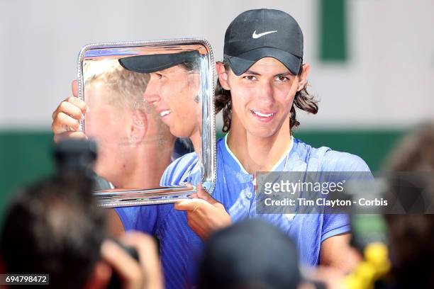 French Open Tennis Tournament - Day Fourteen. Alexei Popyrin of Australian with the trophy after defeating Nicola Kuhn of Spain to win the Boy's...