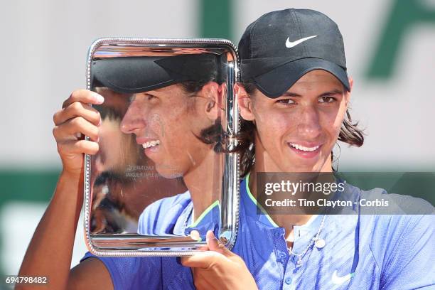 French Open Tennis Tournament - Day Fourteen. Alexei Popyrin of Australian with the trophy after defeating Nicola Kuhn of Spain to win the Boy's...