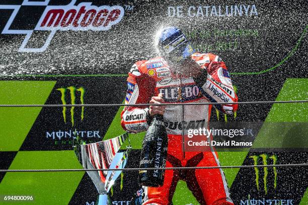 Andrea Dovizioso of Italy and Ducati Team celebrates on the podium after winning the MotoGp of Catalunya at Circuit de Catalunya on June 11, 2017 in...