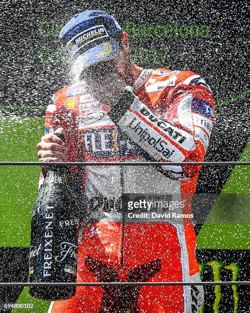 Andrea Dovizioso of Italy and Ducati Team celebrates on the podium after winning the MotoGp of Catalunya at Circuit de Catalunya on June 11, 2017 in...