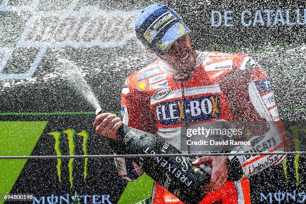 Andrea Dovizioso of Italy and Ducati Team celebrates on the podium after winning the MotoGp of Catalunya at Circuit de Catalunya on June 11, 2017 in...