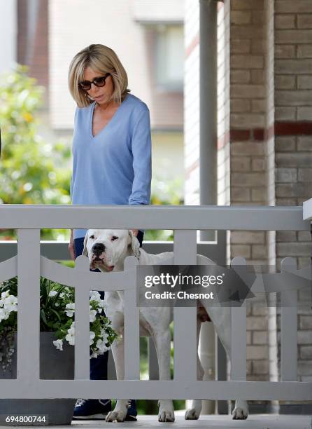 Wife of French President Emmanuel Macron, Brigitte Trogneux is seen on the balcony of her house with her dog as her husband Emmanuel Macron leaves on...