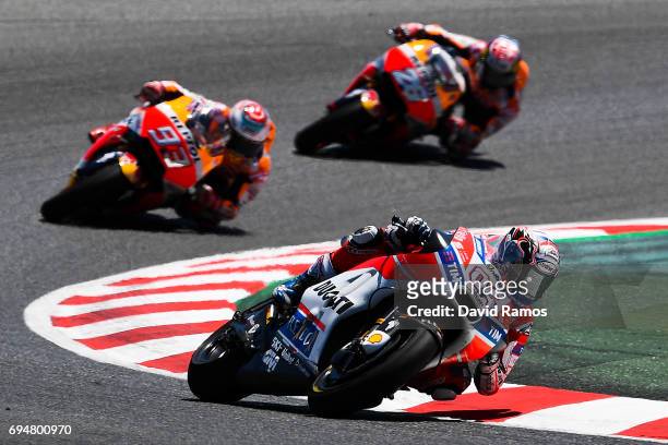 Andrea Dovizioso of Italy and Ducati Team rides to win ahead Marc Marquez of Spain and Repsol Honda Team and Dani Pedrosa of Spain and Repsol Honda...