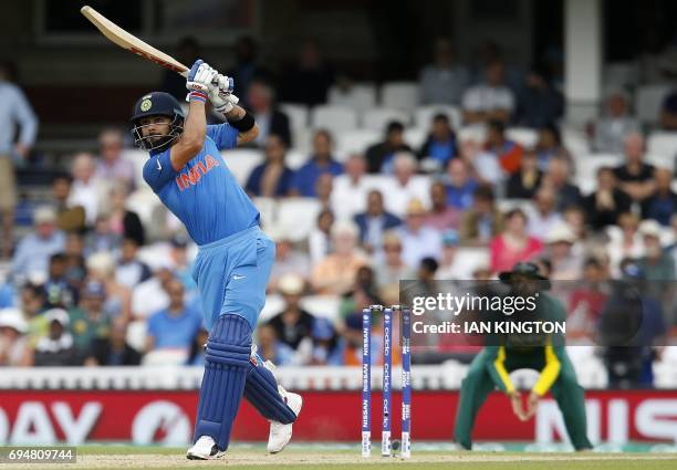 India's captain Virat Kohli hits a six during the ICC Champions Trophy match between South Africa and India at The Oval in London on June 11, 2017....