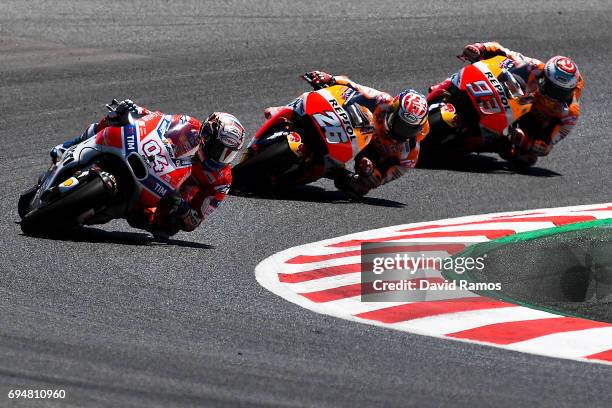 Andrea Dovizioso of Italy and Ducati Team rides to win ahead Marc Marquez of Spain and Repsol Honda Team and Dani Pedrosa of Spain and Repsol Honda...