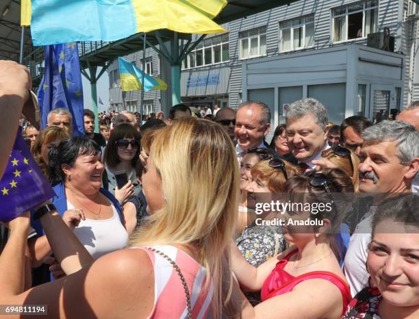 President of Ukraine Petro Poroshenko poses with citizens as he opens symbolic door to EU at Ukrainian-Slovak border in Uzhgorod, Ukraine on June 11,...