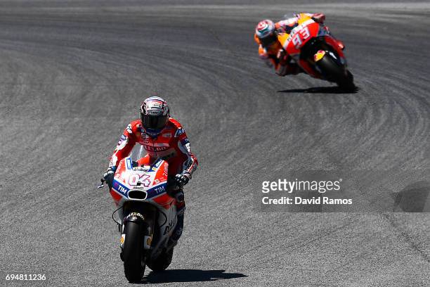Andrea Dovizioso of Italy and Ducati Team rides to win ahead Marc Marquez of Spain and Repsol Honda Team during the MotoGp of Catalunya at Circuit de...