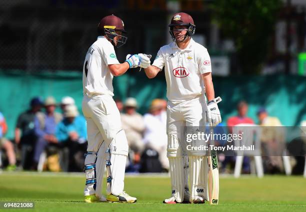Scott Borthwick and Rory Burns of Surrey bump fists during the Specsavers County Championship: Division One match between Surrey and Essex at...