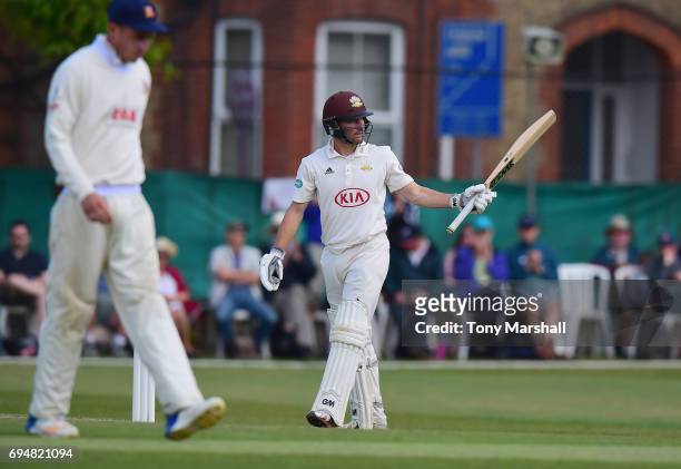 Rory Burns of Surrey celebrates reaching his 50 during the Specsavers County Championship: Division One match between Surrey and Essex at Guildford...