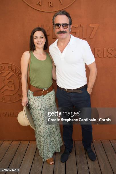 Actor Jean Dujardin and Nathalie Pechalat attend the French Tennis Open 2017 - Day Fifthteen at Roland Garros on June 11, 2017 in Paris, France.