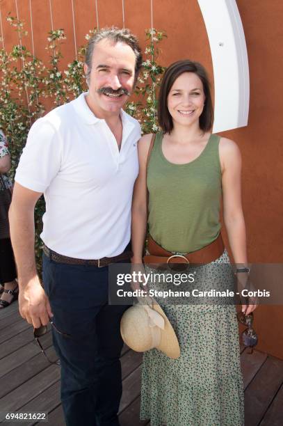 Actor Jean Dujardin and Nathalie Pechalat attend the French Tennis Open 2017 - Day Fifthteen at Roland Garros on June 11, 2017 in Paris, France.