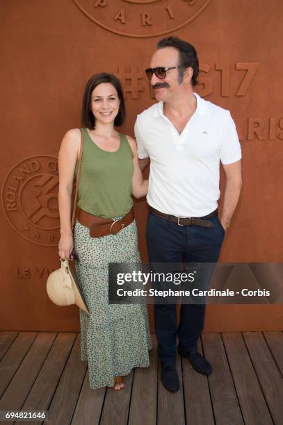 Actor Jean Dujardin and Nathalie Pechalat attend the French Tennis Open 2017 - Day Fifthteen at Roland Garros on June 11, 2017 in Paris, France.