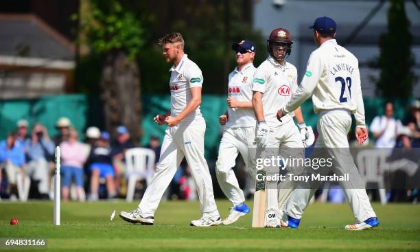 Jamie Porter of Essex celebrates taking the wicket of Rory Burns of Surrey during the Specsavers County Championship: Division One match between...
