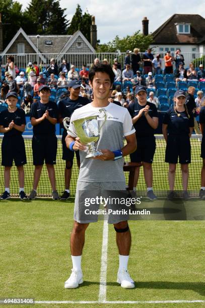 Yuichi Sugita of Japan with the trophy after victory in the final match against Jordan Thompson of Australia during the Aegon Surbiton Trophy tennis...